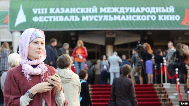People gather outside a cinema during the International Festival of Muslim Cinema in Kazan.