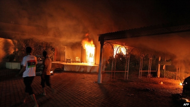 A vehicle and surrounding buildings burn after they were set on fire inside the U.S. Consulate compound in Benghazi, Libya, on September 11.