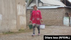 Женщина несет воду. Шымкент, 14 октября 2015 года.