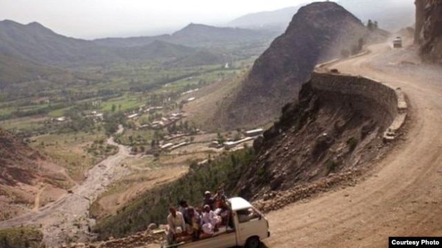 PAKISTAN - Passengers ride along a mountainside road in Pakistan's North West Frontier Province.