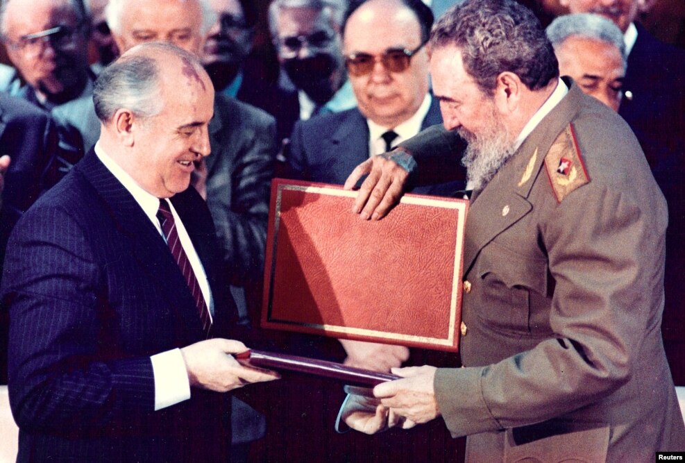 Castro (right) and then-Soviet leader Mikhail Gorbachev exchange documents during a treaty signing ceremony in Havana in 1989. 