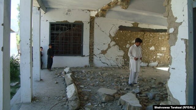 Locals and students inspect the ruins of a government girls high school destroyed by the Taliban in Bajaur Agency in June.