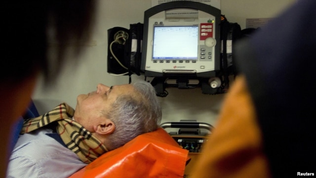 Former Romanian Prime Minister Adrian Nastase is lifted into an ambulance after the reported suicide attempt at his residence in Bucharest on June 20.