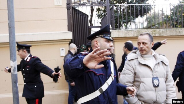Police at work in front of the Chilean Embassy in Rome after a parcel bomb explosion