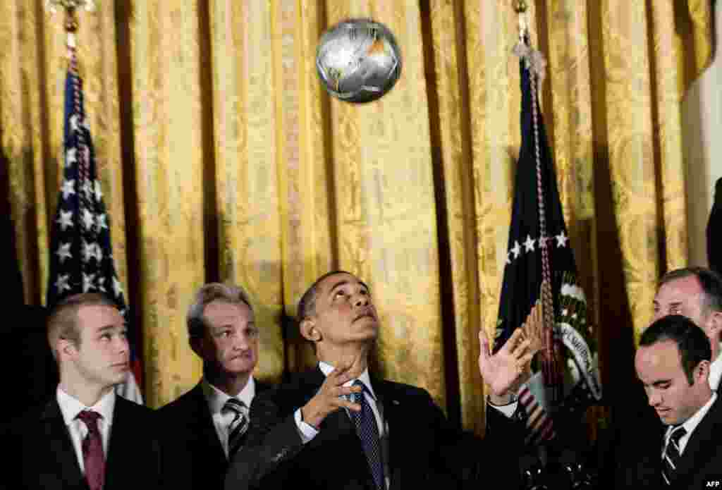 U.S. President Barack Obama bounces a soccer ball off his head during an event at the White House in Washington. Obama hosted an event to honor the 2012 MLS Cup champions, the Los Angeles Galaxy, and the 2012 Stanley Cup champions, the Los Angeles Kings. (AFP/Brendan Smialowski)