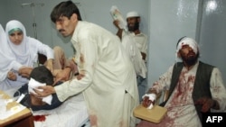 Doctors in Peshawar treat some of the dozens of Pakistanis injured in a suicide blast.