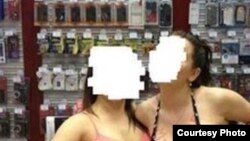 The MTS mobile-phone retailer says provocative staff photos that ended up on social media were taken as part of an "informal team-building exercise."