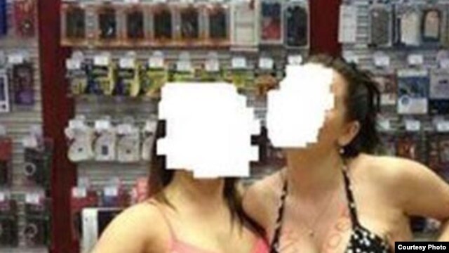 The MTS mobile-phone retailer says provocative staff photos that ended up on social media were taken as part of an "informal team-building exercise."