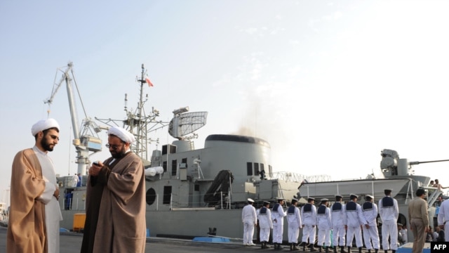 Clerics stand in front of the "Jamaran," Iran's first domestically built warship, during naval maneuvers in the Persian Gulf in February 2010.