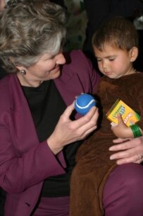 Hughes speaks to an Afghan child during a visit to Kabul on February 26, 2004 (epa)