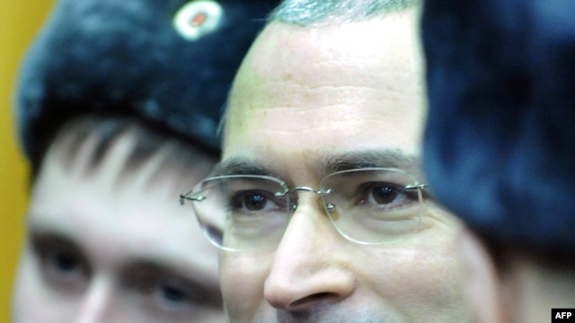 Mikhail Khodorkovsky stands between police officers at a courtroom in Moscow on December 27.