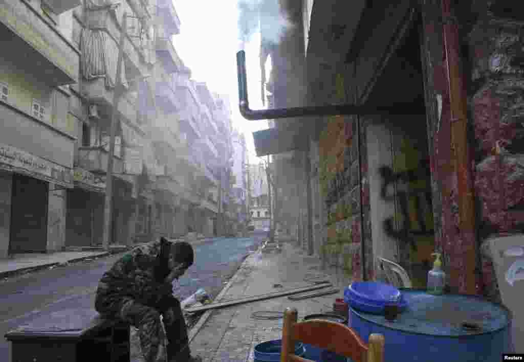 A Free Syrian Army fighter covers his face in the district of Salaheddine in Aleppo. (Reuters/Aref Hretani)