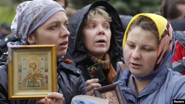 Russian Orthodox believers gather outside a court building during the trial of members of the female punk collective "Pussy Riot" for hooliganism motivated by religious hatred earlier this year. 
