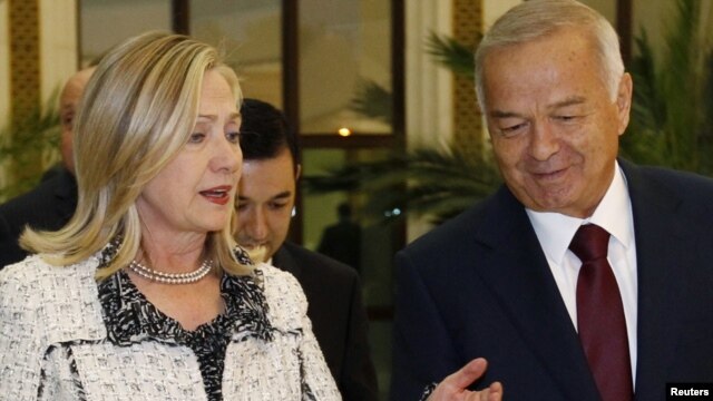 Uzbek President Islam Karimov (right) greets U.S. Secretary of State Hillary Clinton in Tashkent.