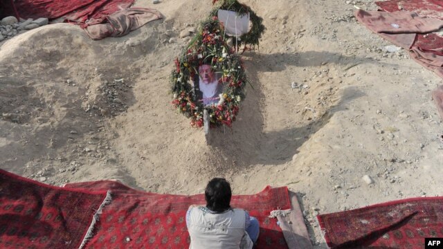 A man prays over the grave site of slain Burhanuddin Rabbani at the Wazir Akbar Khan hilltop overlooking Kabul in 2011.