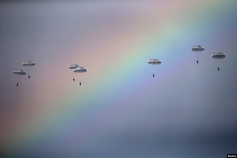 Russian paratroopers jump from an IL-76 transport plane during a joint Serbian-Russian military training exercise in the town of Kovin, near Belgrade. (Reuters/Marko Djurica)