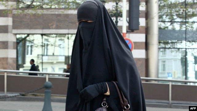 A Muslim woman dressed in niqab walks through the streets of Brussels.