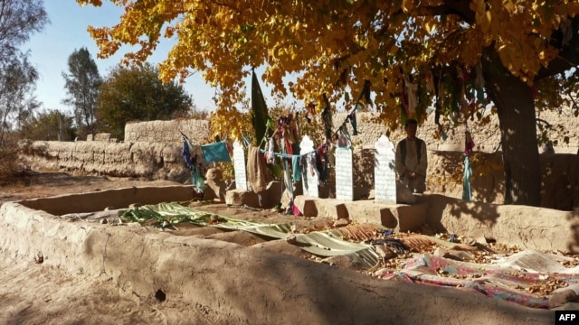 A man stands alongside the graves of some of the 16 Afghan villagers who were killed in the March massacre of which Bales is accused.