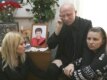 Belarus -- Alyaksandr Kozulin with his daughters Yulia (R) and Volha  (L) near portrait of his deceased wife Iryna at their home in Minsk, 26Feb2008