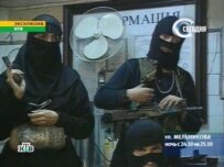 A black widow (left) pictured in a Russian TV capture during the siege (AFP)