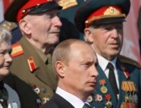 Vladimir Putin watching military parade with World War II veterans on May 9 (epa)