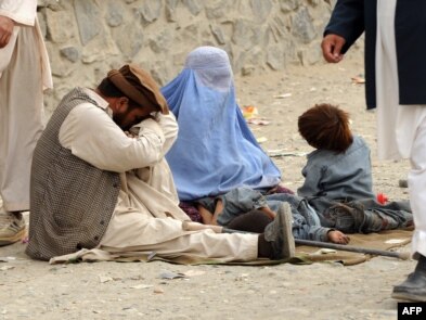 A family begs on the street in Kabul.