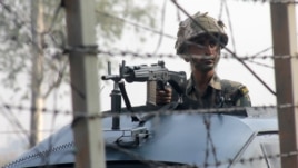 An Indian soldier patrols on the India-Pakistan border.  