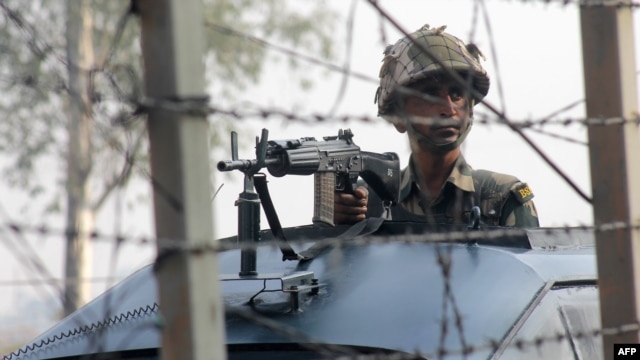 An Indian soldier patrols on the India-Pakistan border.  