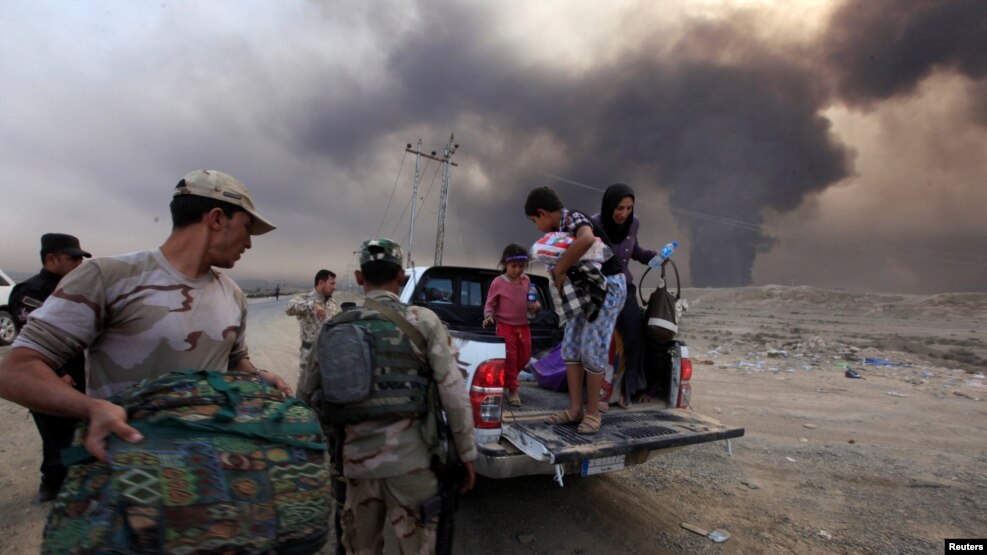 Displaced people seek refuge while fleeing from clashes during an operation to attack Islamic State militants in Mosul on October 19.