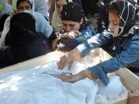 Zakia Zaki's family grieving over her body in Jabbul Saraj today (AFP)
