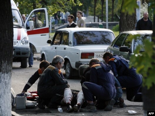 Medics and police help a 
wounded person after the bombing in Stavropol on May 26.