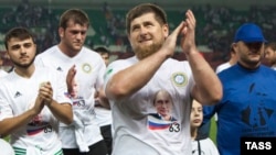 Chechen leader Ramzan Kadyrov claps during celebrations marking the 63rd birthday of Russian President Vladimir Putin in Grozny on October 7.
