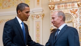 Russia -- US President Barack Obama and Russian Prime Minister Vladimir Putin shake hands during a meeting at the latter's country residence home in Novo Ogaryovo, near Moscow, on 07Jul2009.