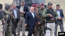 Iraqi Prime Minister Haider al-Abadi (center) visits Ramadi on December 29 after the city had been retaken from Islamic State extremists.