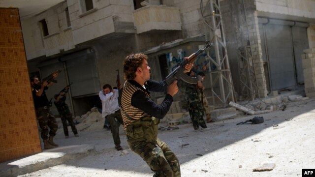 Syrian rebels fire at an army sniper in the Salaheddin district of the northern city of Aleppo on August 13, where fierce fighting continues for Syria's largest city.