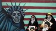 Women hold pictures of Supreme Leader Ayatollah Ali Khamenei outside the former U.S. Embassy in Tehran on November 4, marking the day in 1979 when protesters stormed the embassy and took 52 Americans hostage for over a year.