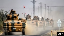 Turkish Army tanks drive to the Syrian border town of Jarabulus on August 25.