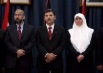 Minister of Finance Mohamed Abd Alrazeq (left), Deputy Palestinian Prime Minister Nasser Asaeer (center), and Minister of Women's Affairs Mream Salaeh (right) at the swearing-in ceremony for the new Hamas government in Ramallah today (epa)