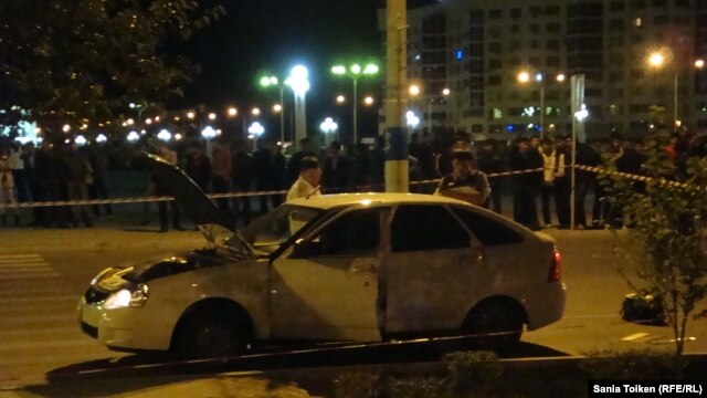 Police inspect a car near the scene of the September 15 incident.