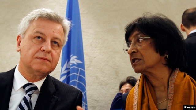 UN High Commissioner for Human Rights Navi Pillay (right) talks to Remigiusz Henczel, president of the Human Rights Council, before the 22nd session of the council at the United Nations in Geneva.