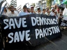 Pakistan - Pakistani activists of the hardline Muttahida Majlis-e-Amal (MMA) carry banners and party flags as they march during an anti-Musharraf protest rally in Islamabad, 16Nov2007