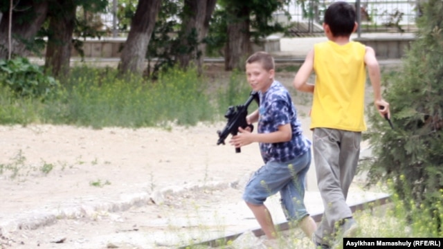 Ақтау қаласындағы "Полицейлер соты" өтіп жатқан ғимарат төңірегінде ойнап жүрген балалар. Ақтау, 7 мамыр 2012 жыл.