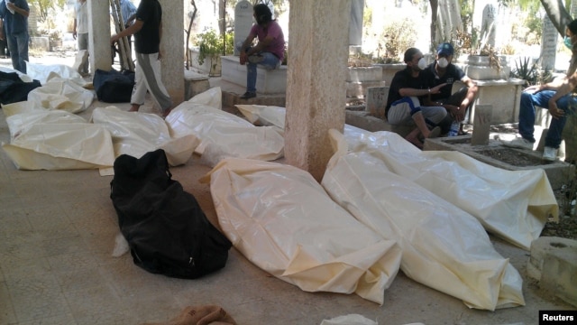 Bodies at a cemetery in the Qabon district of Damascus on July 22