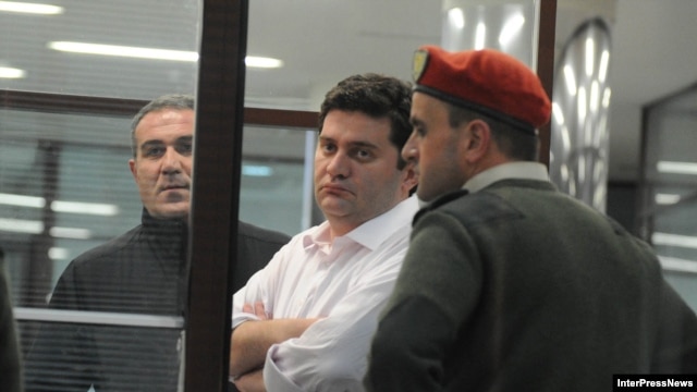 Georgian former Interior Minister Bacho Akhalaia (center) in police custody. 