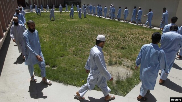 Inmates exercise around a garden at a facility in Kabul of the Afghan National Directorate of Security where would-be suicide bombers are held.