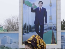 A campaign billboard displays a portrait of President Gurbanguly Berdymukhammedov in Ashgabat.