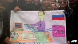 Syrians in the northwestern town of Kfar Nubul pose with a cartoon depicting Russia's Vladimir Putin defibrillating Syrian President Bashar al-Assad by using a veto to block a UN resolution against Assad.
