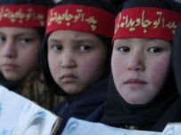Afghan girls carrying posters of Mujahedin at a rally in support of the bill last month (epa)