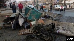Civilians inspect the aftermath of car bomb attack that exploded in Baghdad earlier this week. Iraq has been gripped by violence in recent months.