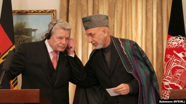 Afghan President Hamid Karzai (right) speaks with German President Joachim Gauck during a press conference at the Presidential Palace in Kabul on December 18.